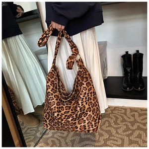 Detail shot of leopard print canvas tote bag featuring large capacity and knotted handle style