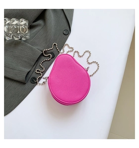 Detail of rose pink avocado-shaped mini bag with pebble leather texture and silver ball chain