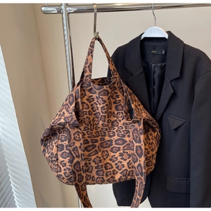 Detail shot of large leopard print tote bag with thick canvas texture and sturdy handles