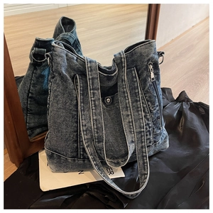Detailed macro view of retro washed denim tote bag texture with metal zipper pocket