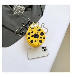 Detailed close-up of yellow ladybug mini PU crossbody bag with metal chain strap