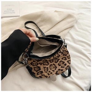 Detail view of leopard print crossbody bag showing interior lining and inner pocket