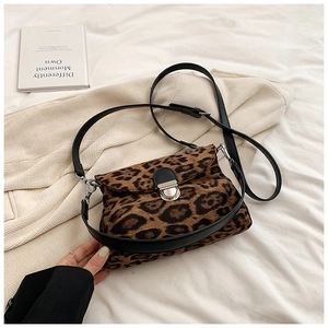 Close-up of leopard print crossbody bag with velvet texture and silver metal lock