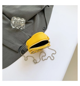Close-up of yellow ladybug-style mini PU leather crossbody bag with silver bead chain