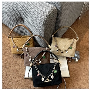 Quilted velvet mini bags in yellow, brown, and black with gold heart chain charms