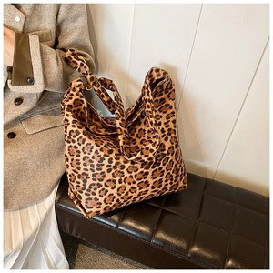 Detailed view of leopard print canvas tote bag with stylish knotted shoulder strap
