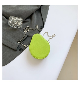 Detail of avocado shaped mini crossbody bag in neon green with litchi grain leather finish