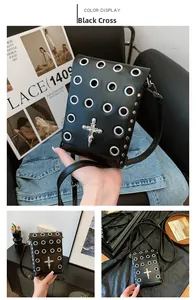 Detail of gothic black crossbody bag with silver eyelets and skull cross ornament