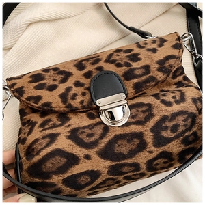 Macro detail of leopard print shoulder bag featuring silver metal flip-top lock and black PU strap