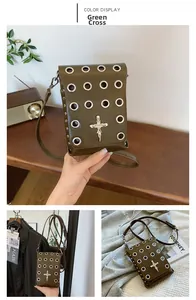 Detail view of olive green crossbody bag with silver skull cross and metal grommets