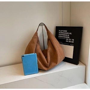 Brown suede tote bag shown with a tablet to demonstrate large capacity storage