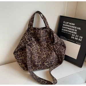 Close-up of leopard print canvas tote bag with dual straps and spacious interior detail