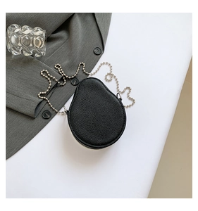 Detailed close-up of a pear-shaped black lychee pattern leather bag with silver bead chain