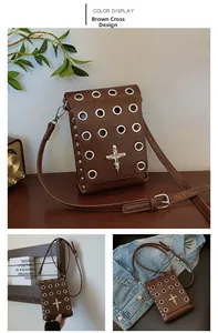 Detail of brown vintage crossbody bag with silver eyelets and metal cross ornament