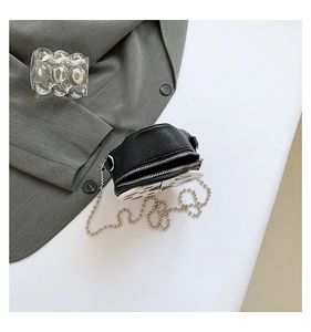 Detail of mini animal pattern PU crossbody bag with silver chain and cow print panel