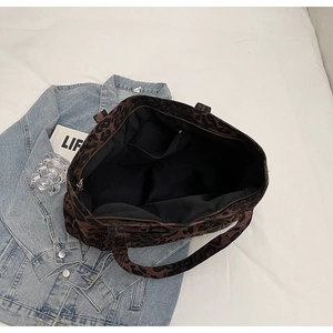 Top view of the spacious leopard print tote bag interior with zipper pocket and black lining