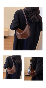 Detail view of brown PU leather hobo bag with gold hardware and adjustable strap