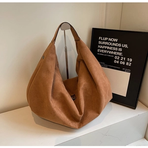 Detailed texture of tan suede tote bag with minimalist large capacity design
