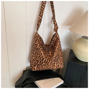 Detail of trendy leopard print canvas tote bag with a stylish knotted shoulder strap
