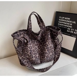 Macro detail of large leopard print tote bag with durable canvas and shoulder straps