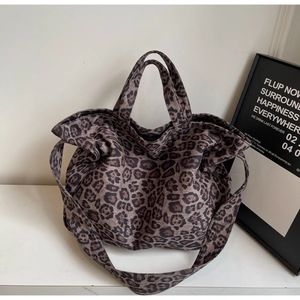 Detailed macro view of high-capacity leopard print tote bag with soft canvas texture
