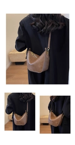 Detailed view of the medium brown retro hobo bag with gold hardware and adjustable strap