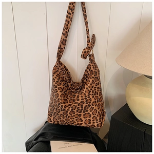 Detail of leopard print canvas tote bag with unique knotted shoulder strap design