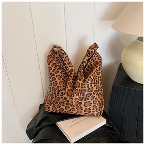 Detail view of the durable canvas leopard print tote bag with a stylish knotted handle design