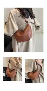 Detail view of caramel brown bucket bag featuring stylish knotted strap and golden hardware