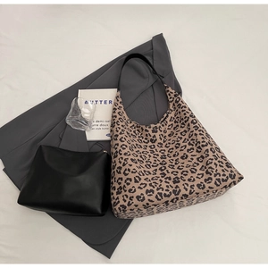 Détail du grand sac cabas léopard avec pochette intérieure noire sur fond élégant