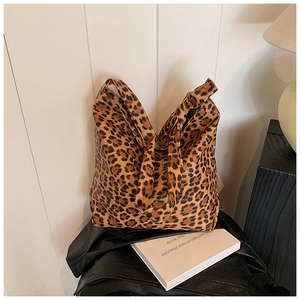 Detail shot of leopard print canvas tote bag with textured handle and trendy pattern