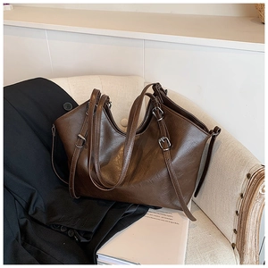 Detailed shot of dark brown tote bag with vintage texture and adjustable side straps