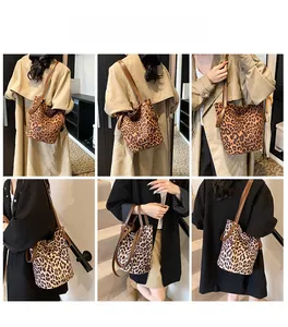 Detailed views of leopard print bucket bag with brown leather straps and spacious interior