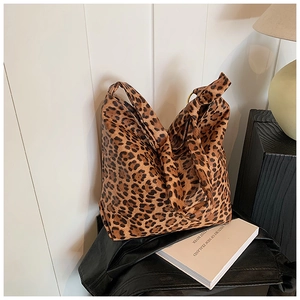 Detail of leopard print canvas tote bag with gold metal ring and soft texture