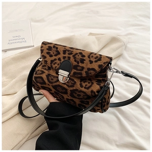 Detail of leopard print crossbody bag featuring a silver metal clasp and leather strap