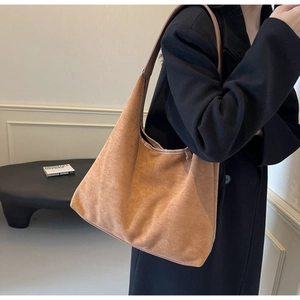 Détail du sac hobo en daim marron avec bandoulière et design spacieux et souple