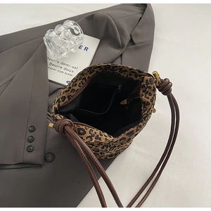 Detailed view of leopard print canvas bucket bag interior with black lining and zipper pocket