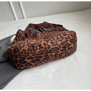 Detailed view of large leopard print tote bag with soft texture and wide shoulder strap