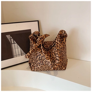 Detailed view of leopard print canvas tote with stylish knot handle and metal ring