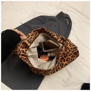 Detailed interior of the leopard print canvas bag showing pockets and large capacity