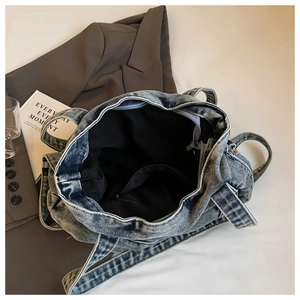 Detail view of the spacious denim tote bag interior with a secure zipper pocket