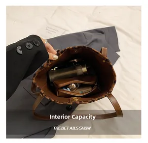 Top-down macro shot showing spacious interior of the leopard bucket bag with compartments