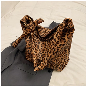 Detail of leopard print canvas tote with knotted strap and gold ring hardware