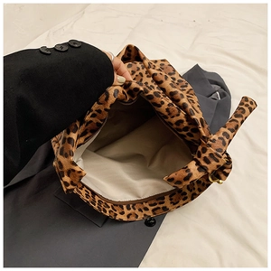 Detail showing the leopard print canvas interior lining and secure zipper pocket