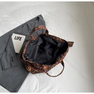 Detail view of large leopard print tote bag with inner pocket and spacious black lining