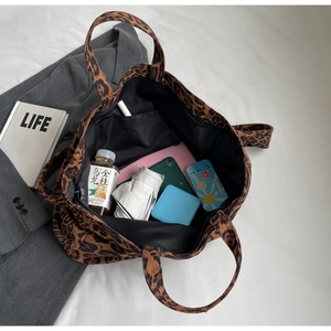 Interior view showing the large capacity of leopard print tote bag with daily essentials