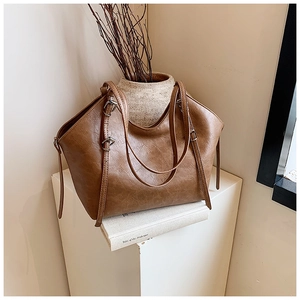 Detail view of the retro brown tote bag with adjustable straps and vintage leather texture