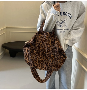 Detail shot of the large leopard print tote bag with thick canvas texture and straps