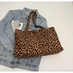 Detail of leopard print tote bag placed on denim jacket for a trendy lifestyle look