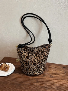 Chic leopard print bucket tote bag with round gold rose charm and black rope straps